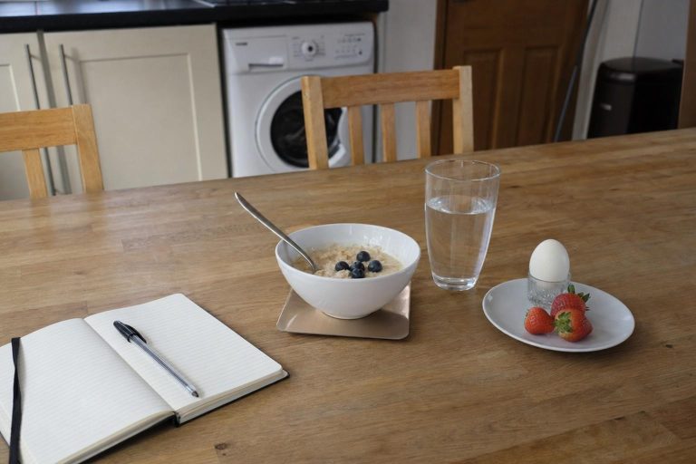 A simple healthy meal and a notebook on a kitchen table